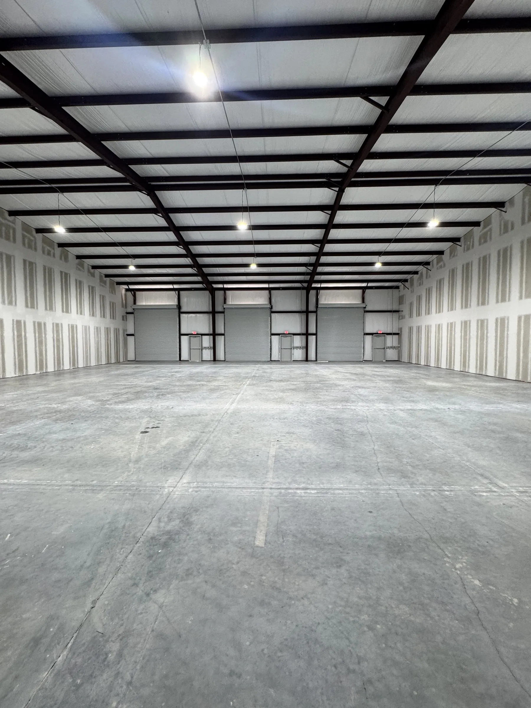 A combined run of bays with the demising walls removed, forming one clear open space.